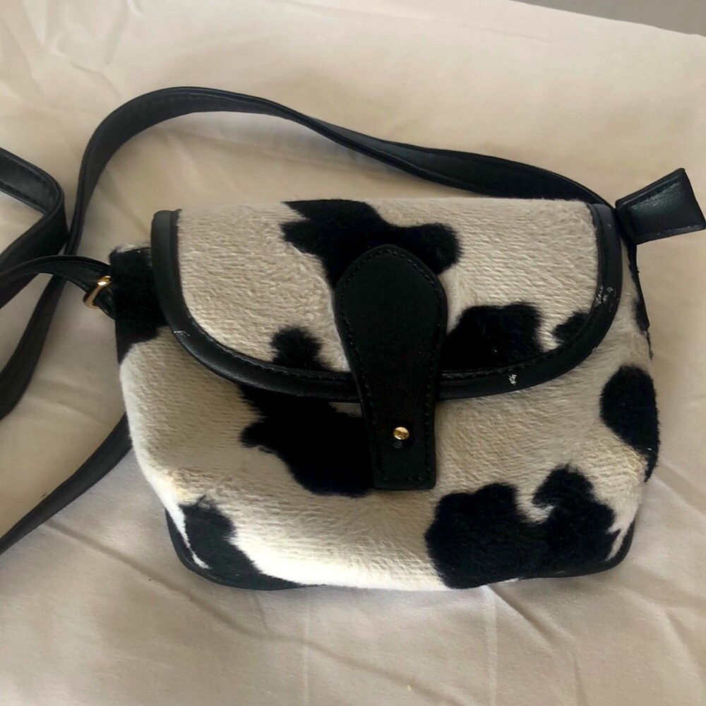 OLIVIA MILLER black and white cow print crossbody.